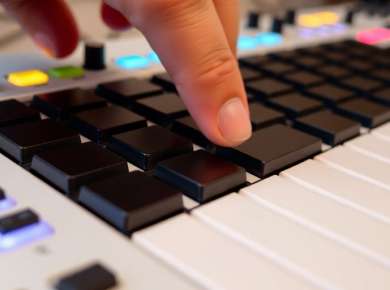 MIDI-Controller mit leuchtenden Tasten und Reglern.